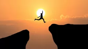 Courage man jump through the gap between hill ,Business concept