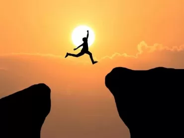 Courage man jump through the gap between hill ,Business concept